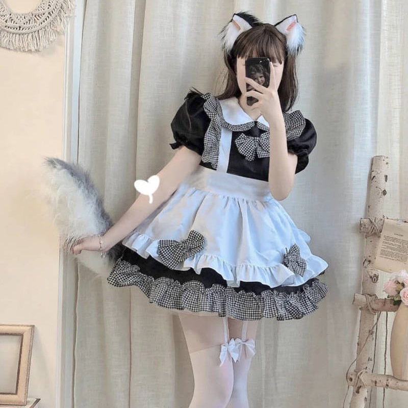 Cosplayer in maid outfit with cat ears and feather duster from French Maid Cosplay collection