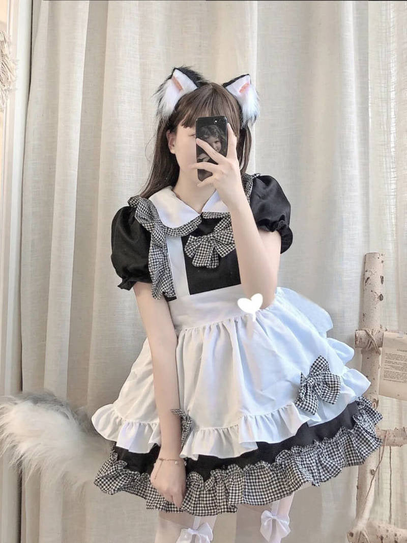 Cosplayer in cat ears and maid outfit takes mirror selfie, perfect for French Maid Cosplay