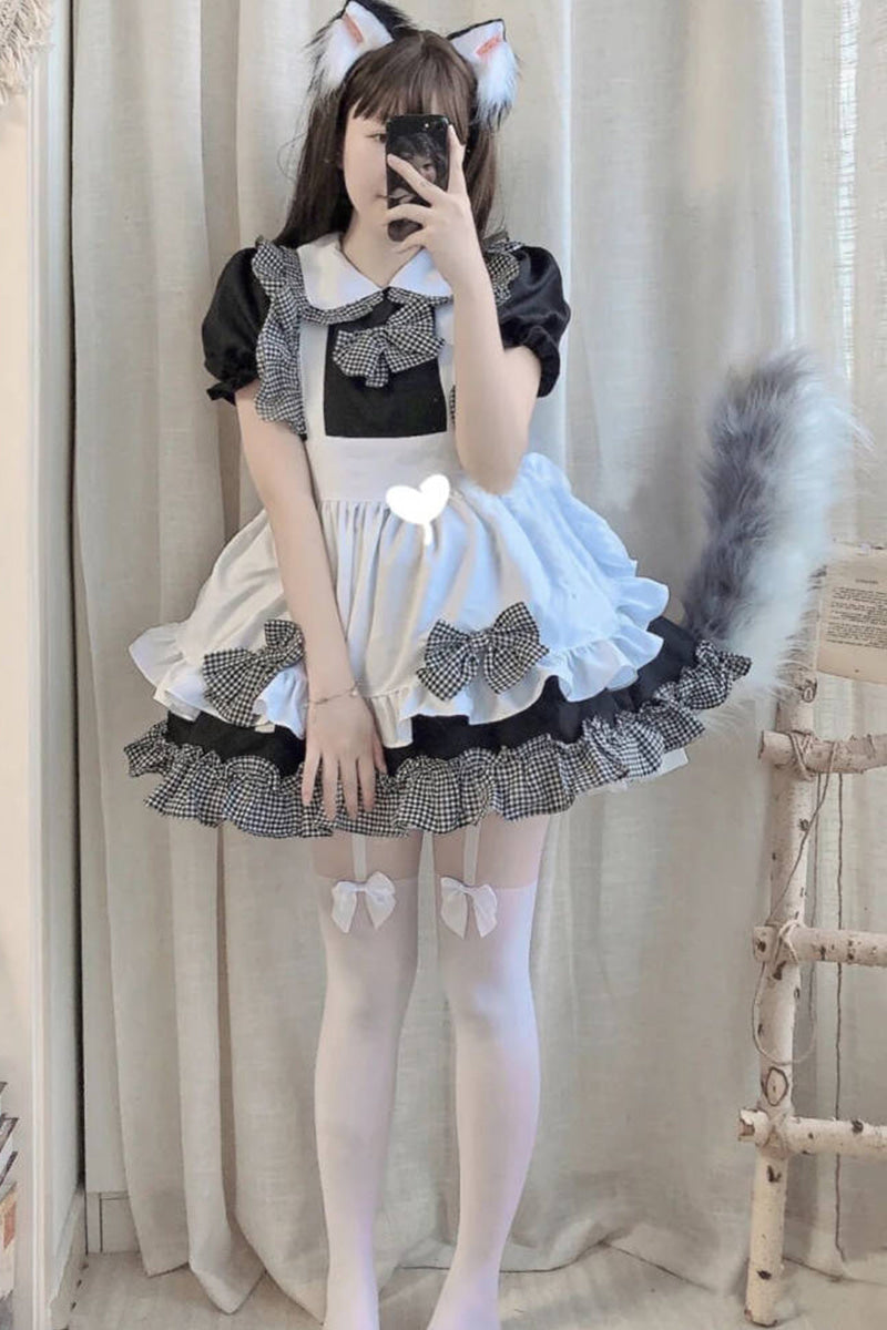 Person in black and white maid cosplay outfit with cat ears and fluffy tail accessory