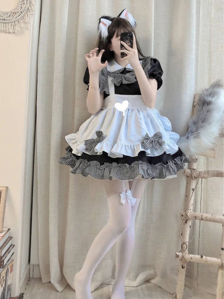 Cosplayer in black and white maid cosplay with cat ears snaps a mirror selfie