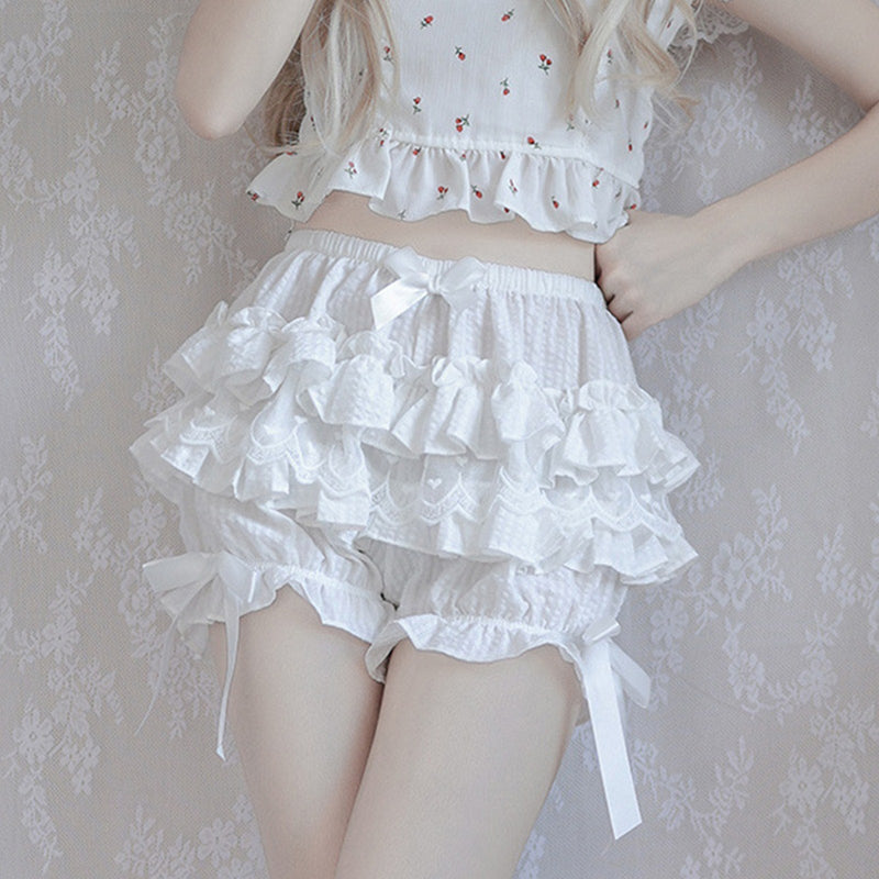 Frilly white ruffled shorts with bow ties on the sides.