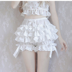 Frilly white two-piece outfit with a cropped top and ruffled shorts.