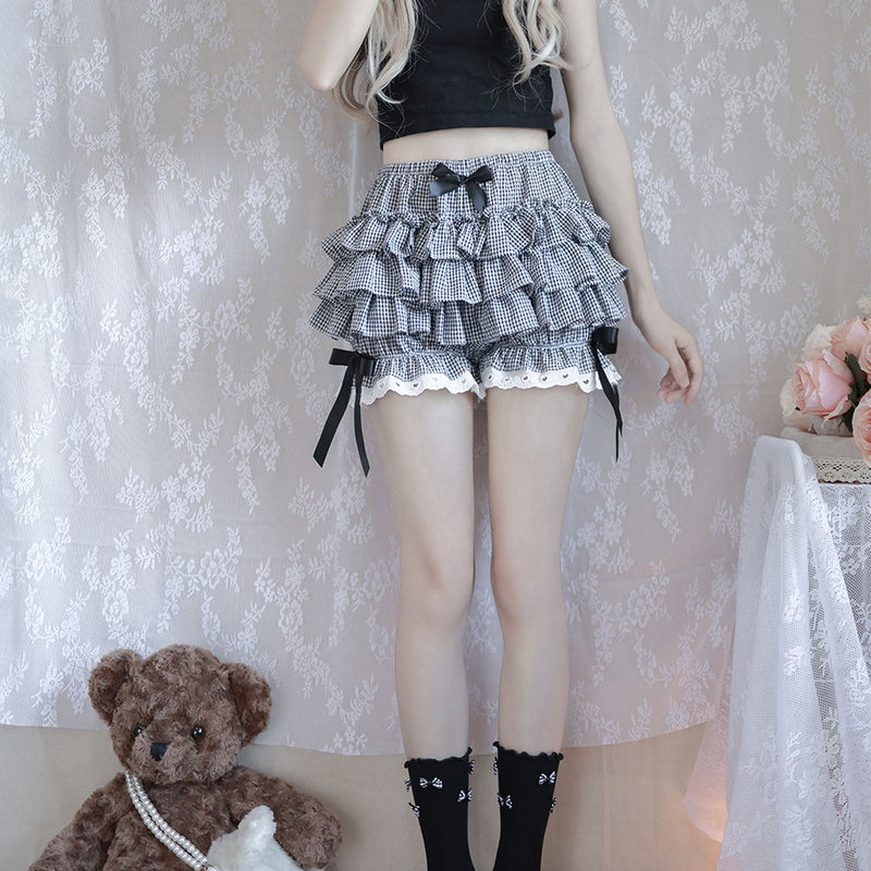 Ruffled gingham skirt with black bows and white lace trim.