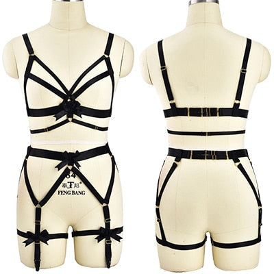 Black strappy harness-style lingerie set displayed on mannequin forms.