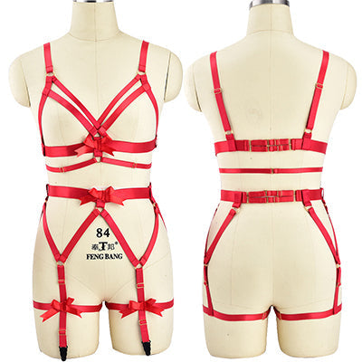 Red strappy lingerie set with harness-style details displayed on mannequin forms.